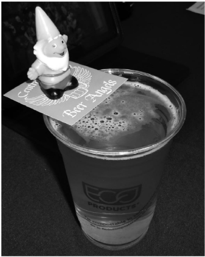 Specialty beer brewed for Central Oregon Beer Week 2013; participants who found a gnome were awarded passes to the little woody. Image sourced from <a data-cke-saved-href='/Products/9781626194670' href='/Products/9781626194670'>Bend Beer: A History of Brewing in Central Oregon</a> A photo of craft beer during Central Oregon Beer Week, with a gnome prize on top.