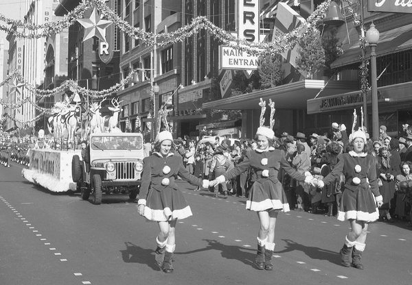 Reprinted from <a data-cke-saved-href='/Products/9781467127653' href='/Products/9781467127653'>Tulsa Christmas Parade</a> by Jessica Gullo, courtesy of Dewey F. Bartlett Jr. (pg. 110, Arcadia Publishing, 2017). This photo shows some of Santa’s helpers on South Main Street during the Tulsa Christmas Parade in 1949.