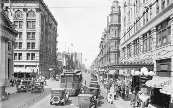 Reprinted from <a data-cke-saved-href='/Products/9780738529240' href='/Products/9780738529240'>The Historic Core of Los Angeles</a> by Curtis C. Roseman, Ruth Wallach, Dace Taube, Linda McCann, and Geoffrey Deverteuil, courtesy of CHS (pg. 27, Arcadia Publishing, 2004). At the corner of Fourth and Main in Los Angeles, traffic is bustling in this 1924 photo.