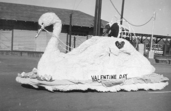 A Valentine’s Day float in the 1953 Needles holiday parade. The float featured a swan, a popular symbol of the holiday. Reprinted from <a data-cke-saved-href='/Products/9780738580647' href='/Products/9780738580647'>Needles</a> by James M. Conkle and Linda Fitzpatrick, courtesy of Linda Daniel Andrews (pg. 91, Arcadia Publishing, 2010). A Valentine’s Day float in the 1953 Needles holiday parade.