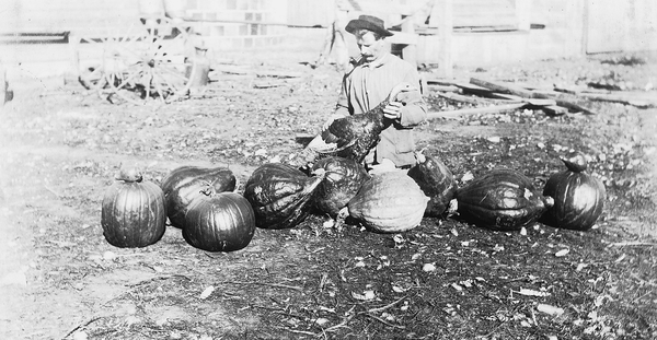 A farmer poses with his farm-raised turkey.
