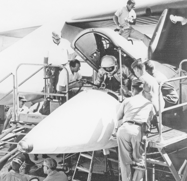 Airman Pete Knight lowers himself into the cockpit of an X-15A-2.