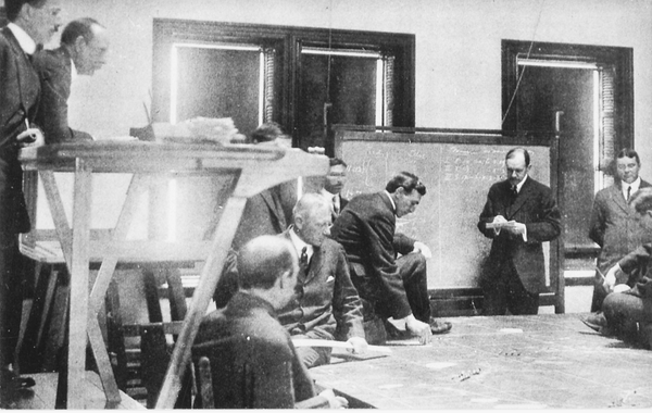 In this 1914 photo, a group of officer students play a naval war game as a part of their stories at the Naval War College in Newport.
