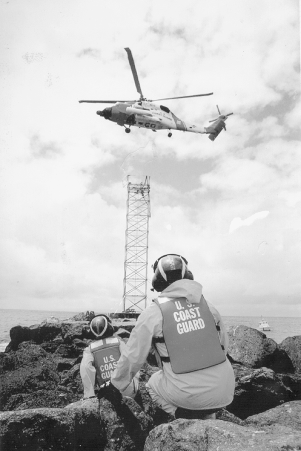 A Coast Guard team delivers a battery to a south jetty near Mission Bay, in San Diego.