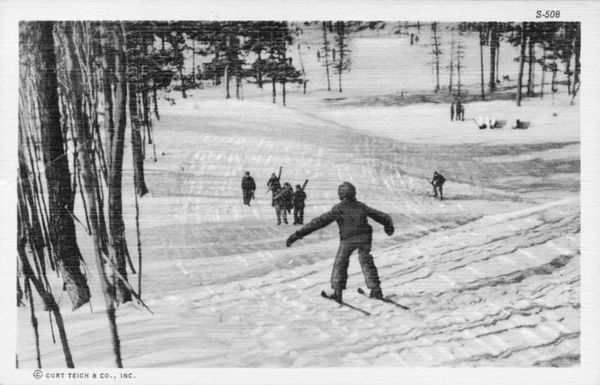 A group of skiers hikes up one of the Catskill mountains.