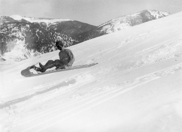 Fred Brand of the Western State Hiking and Outing club riding a toboggan in 1932.