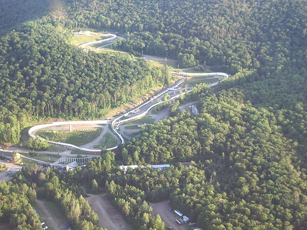 The current bobsled track in Lake Placid, New York. Public Domain image via Wikimedia Commons.